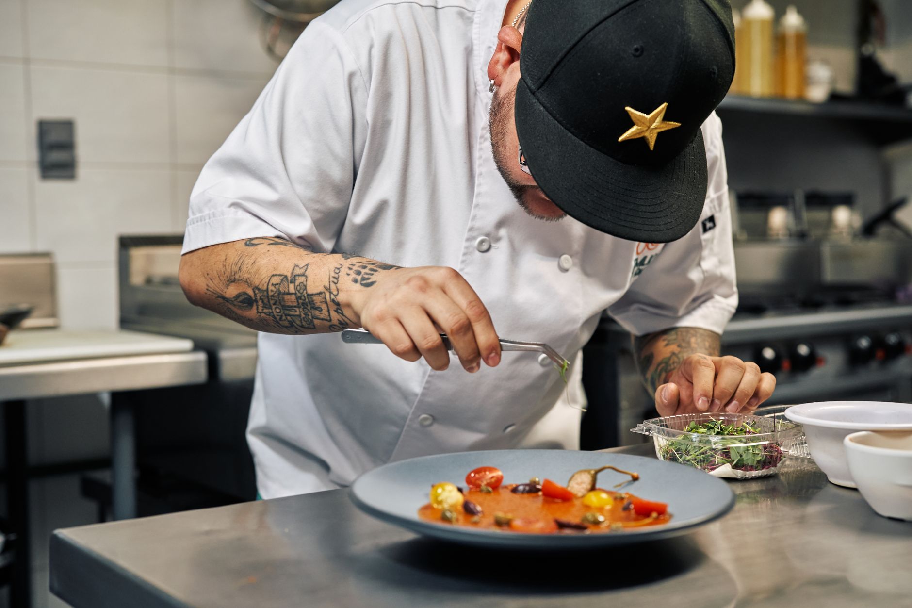 A chef in quiet concentration at the pass